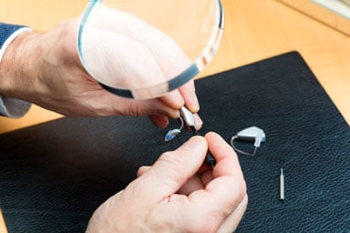 Hearing aid repair and maintenance being done