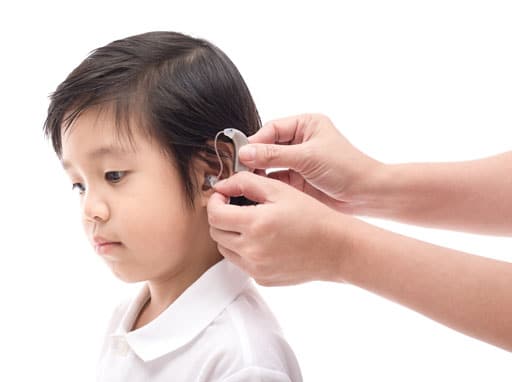 Child being fitted for hearing aid