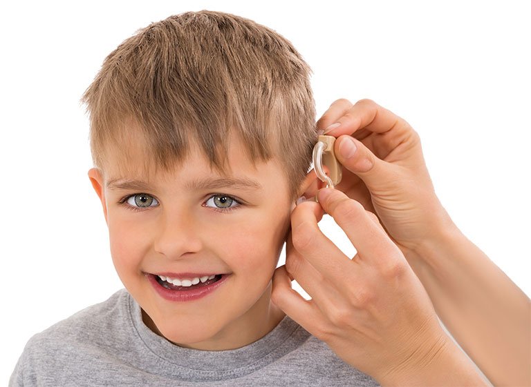pre teen being fitted for hearing aid